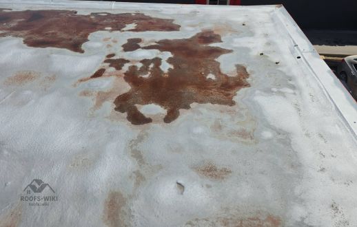 Ponding water stains on a flat roof in Winnipeg, MB
