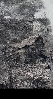 Weathered and patched membrane roof in North Miami Beach, FL