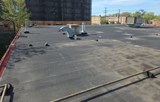 Ponding water with rust staining on a flat roof in Winnipeg, MB