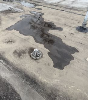 Ponding and staining on a gravel roof in Des Plaines, IL