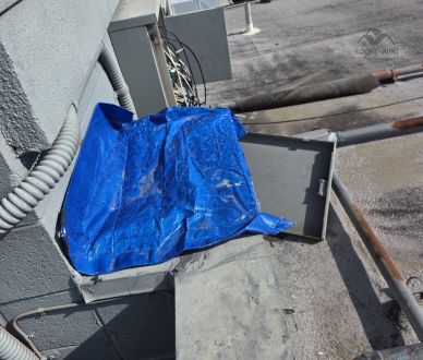 Large blue tarp covering a roof in Los Angeles, CA
